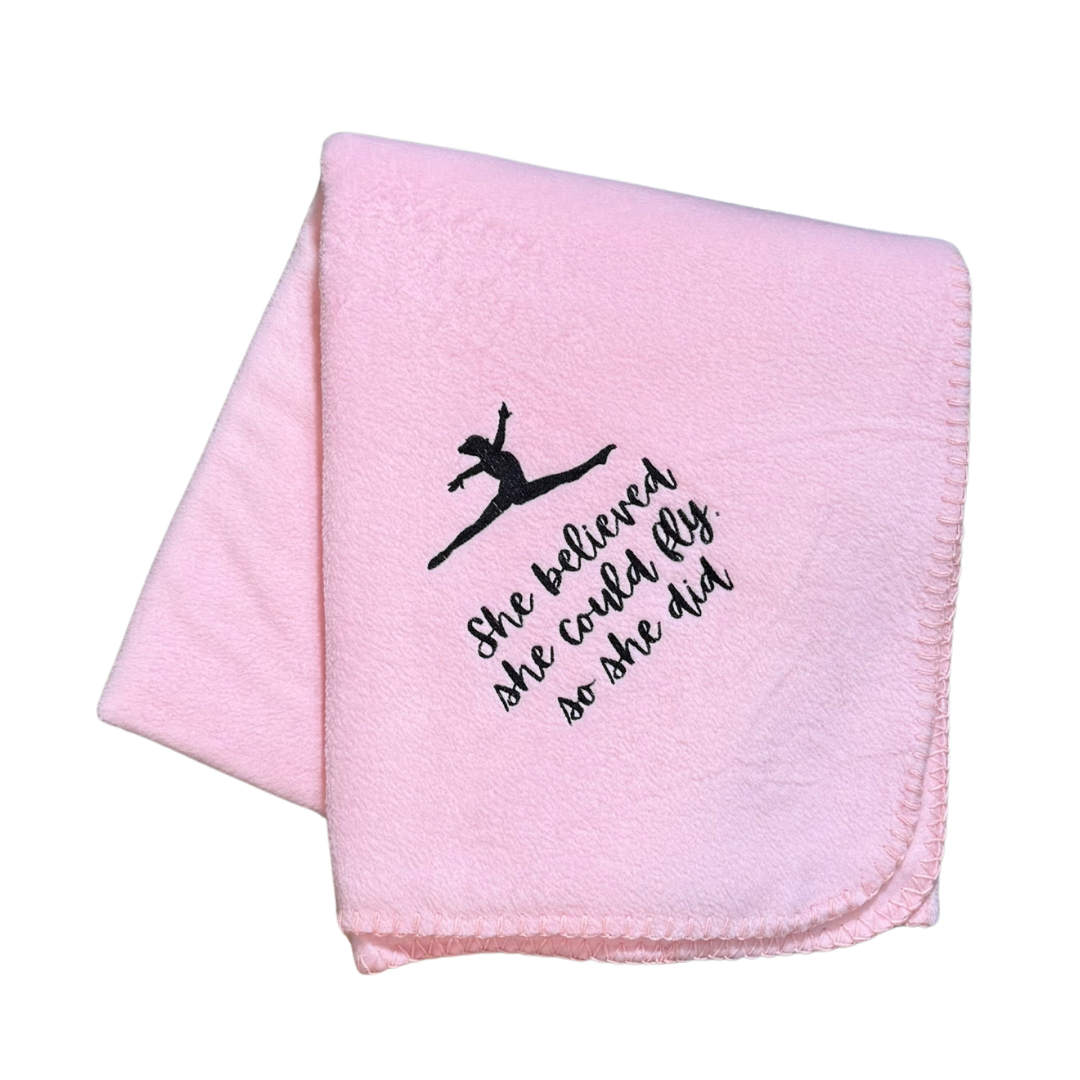 Pink blanket with black text and silhouette of a gymnast