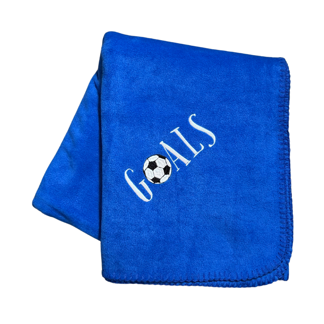 Blue blanket with 'GOALS' and a soccer ball design in white embroidery