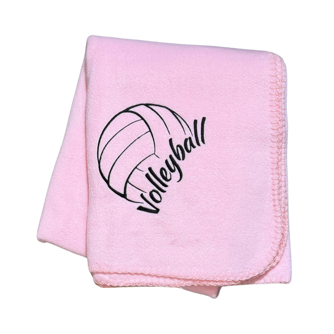 Pink blanket with volleyball design and text in black