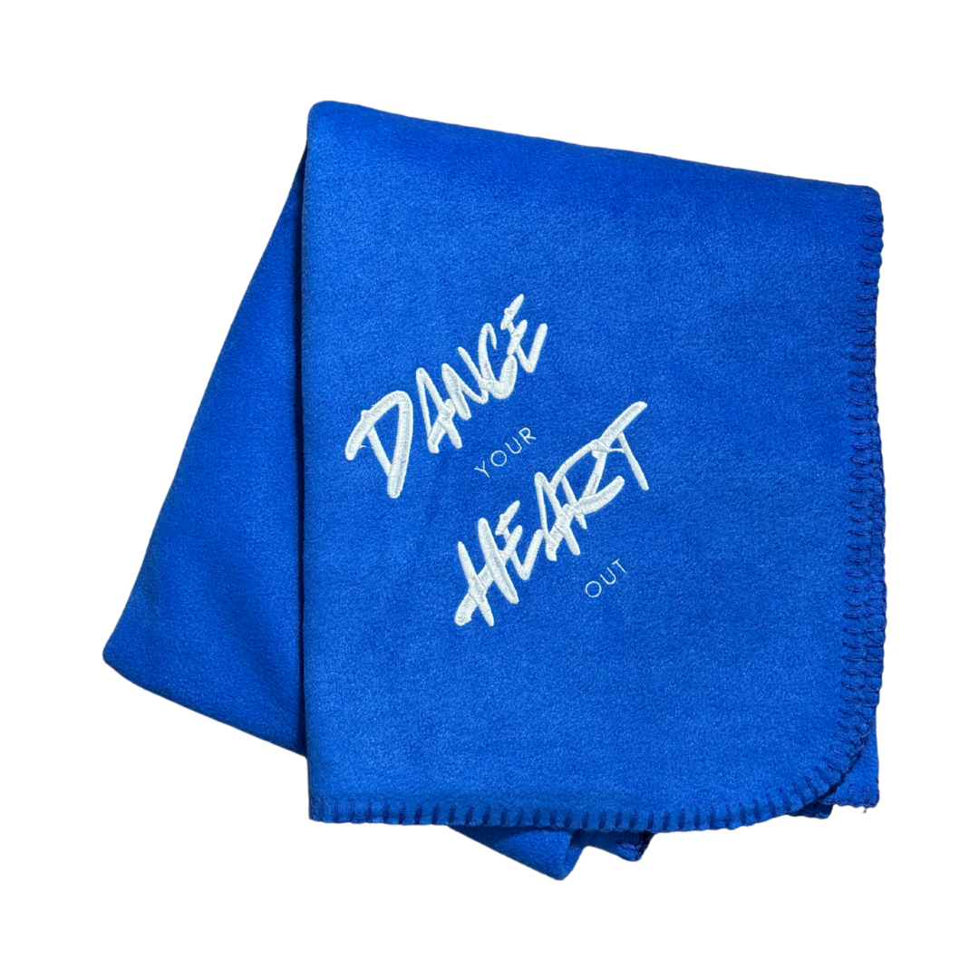Blue blanket with 'Dance Your Heart Out' text in white embroidery