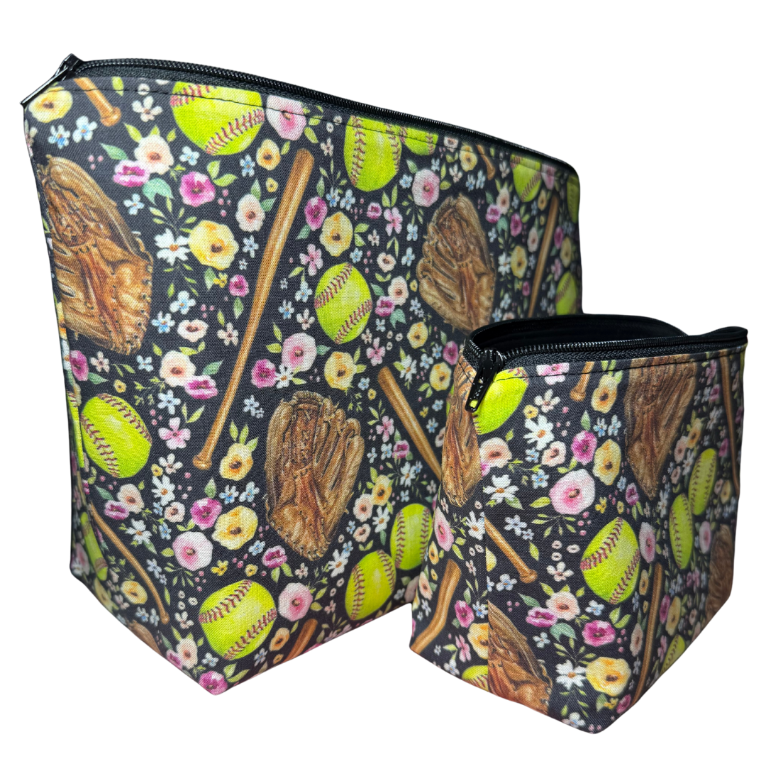 Two zippered pouches with floral and softball design on a black background