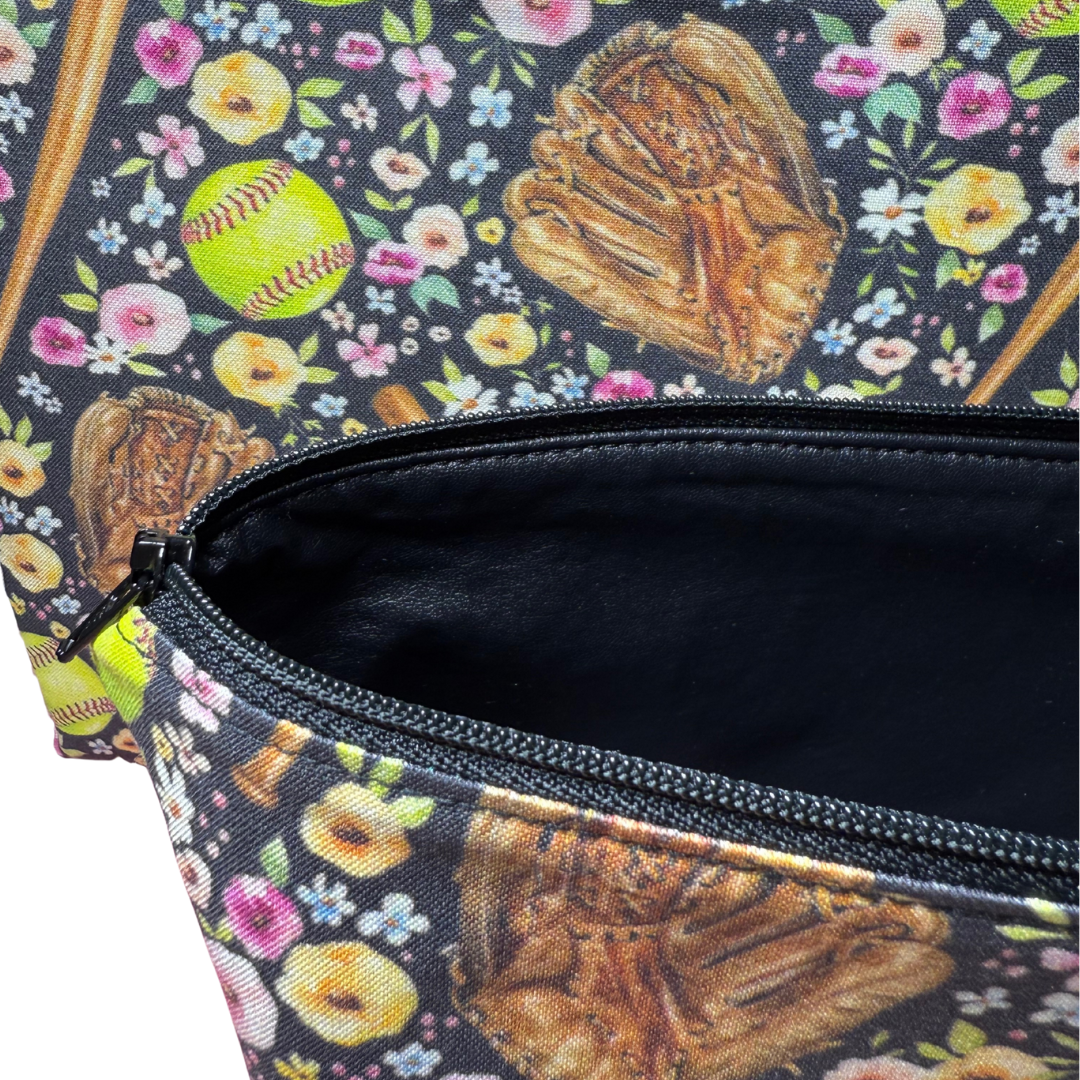 Floral-patterned bag with softball design, open to reveal black interior vinyl lining