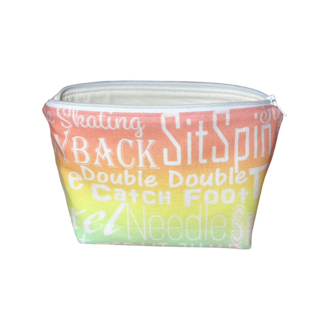 skating makeup bag in peach, yellow and pale green with skating words