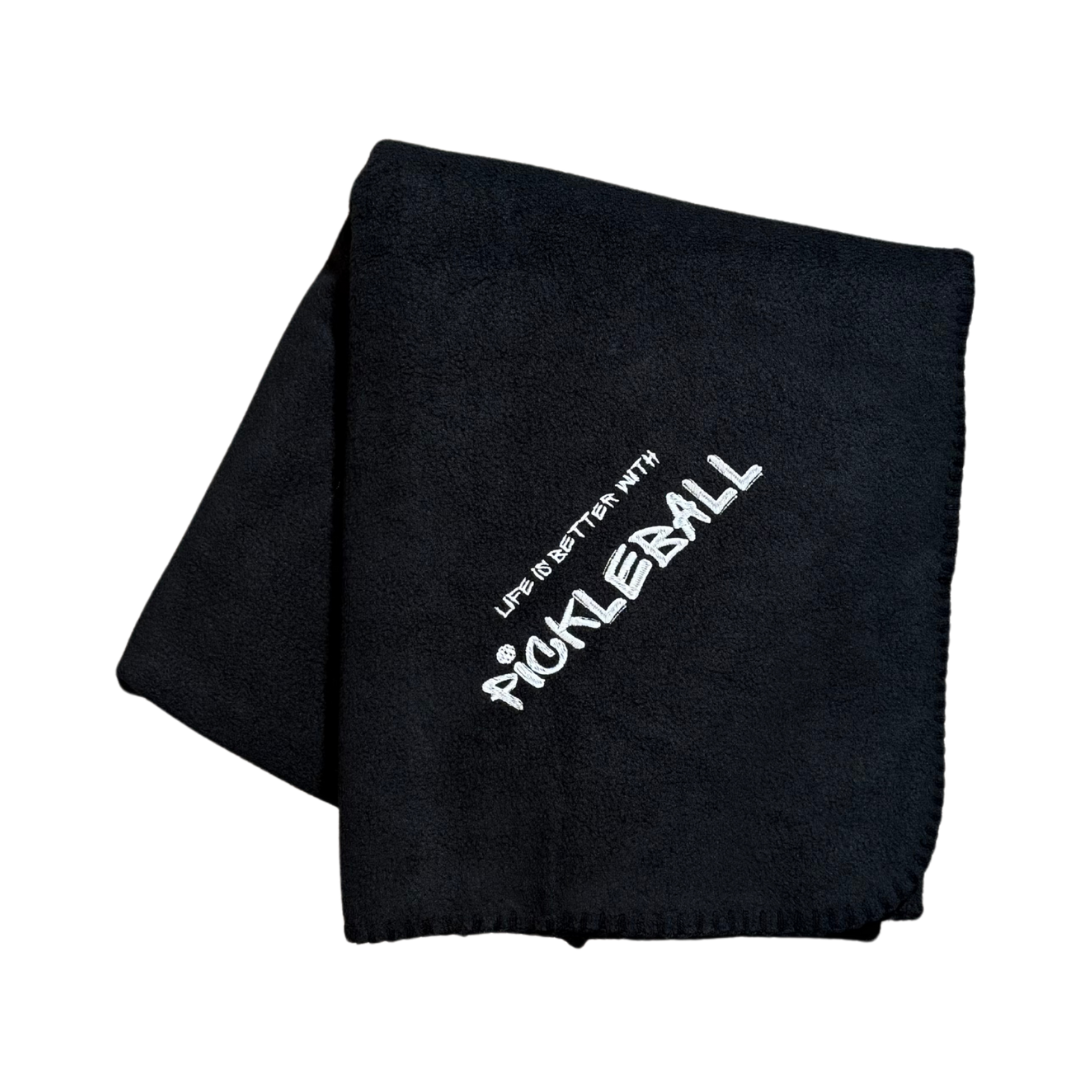 Black fleece blanket with 'Life is Better with Pickleball' text in white