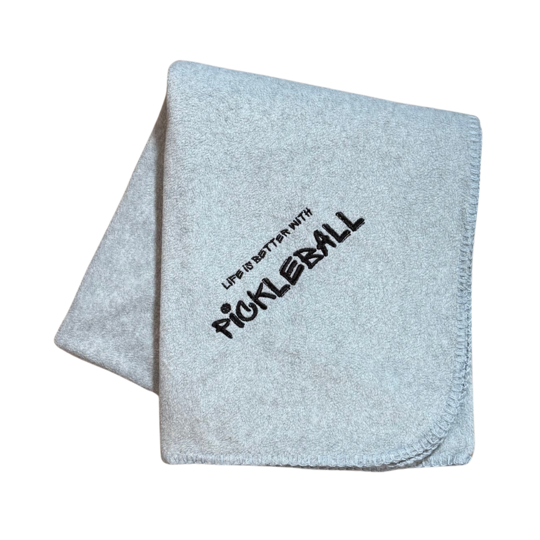 Gray blanket with 'Life is better with Pickleball' text in black