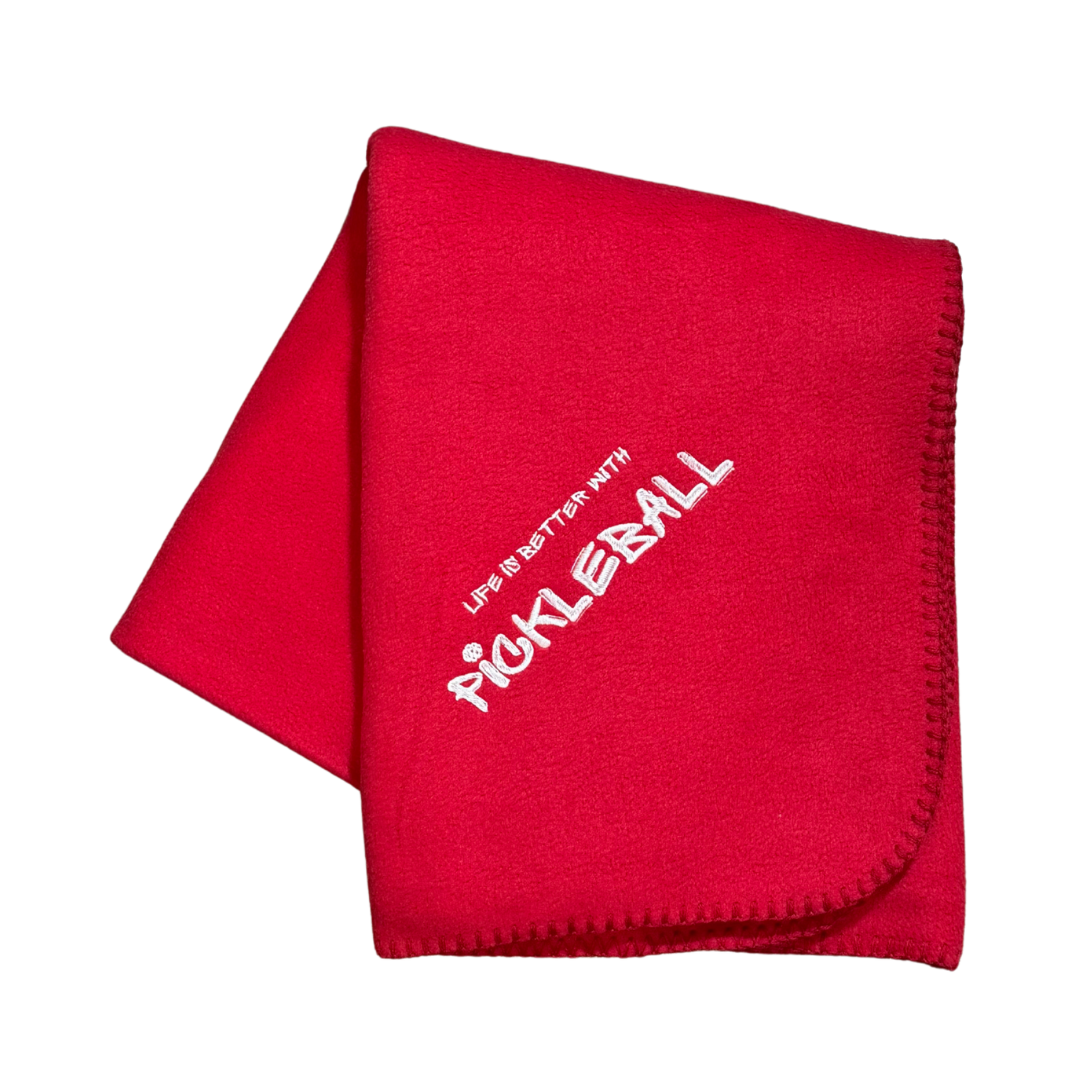 Red blanket with 'Live in Batter with Pickleball' text in white embroidery