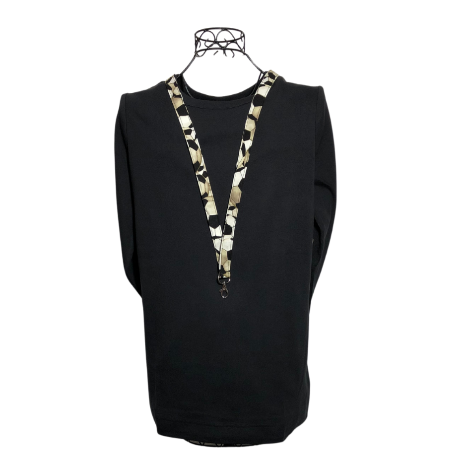 black and white soccer lanyard on a mannequin wearing a black shirt