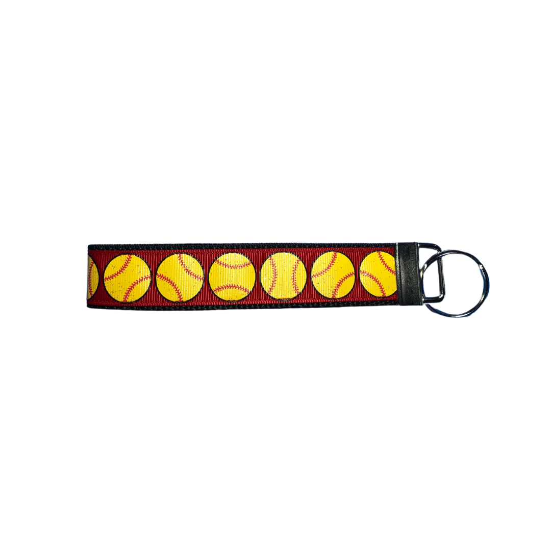 red softball wrist keychain with glittery yellow softballs