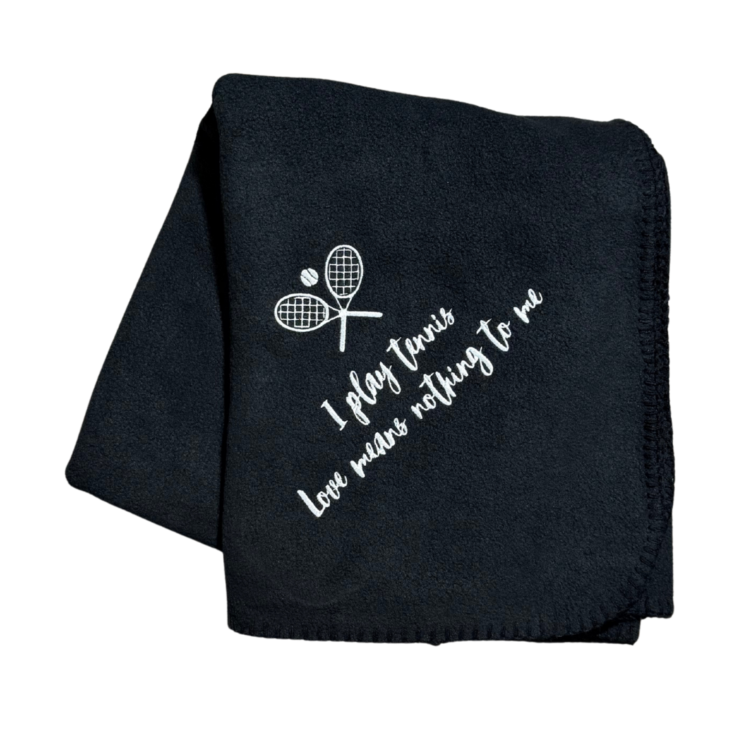 Black blanket with white text and tennis racket design in white embroidery