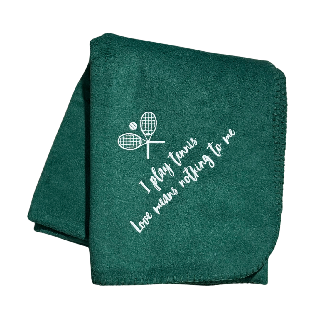 green tennis fleece blanket with white text and racket design