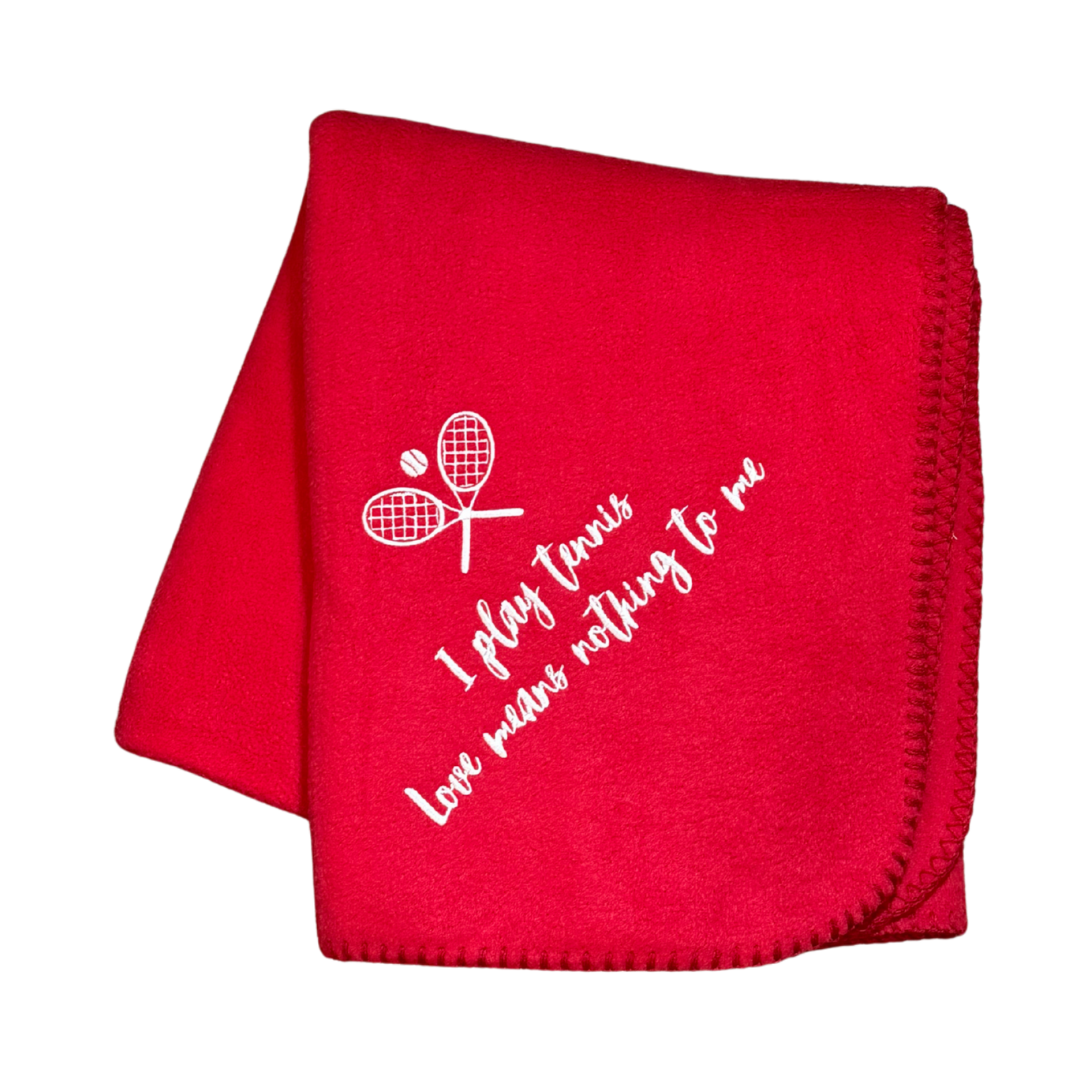 Red blanket with white text and tennis racket design