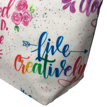 girl power cosmetic bag with "live creatively" phrase in rainbow script