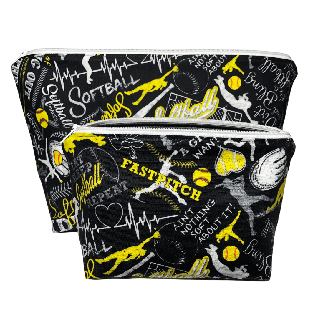 pair of two black softball makeup bags with softball words and images in white, gray, and yellow