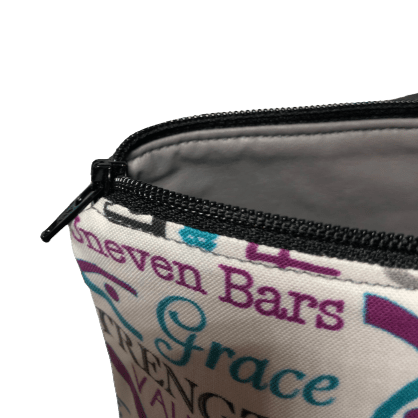 gymnastics makeup bag with black zipper and gray vinyl interior