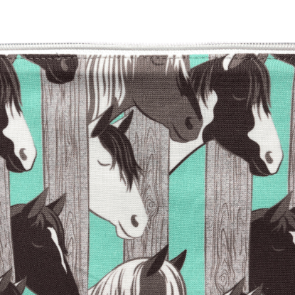 horse zippered bag with aqua and gray wide vertical stripes and horse heads poking through the stripes