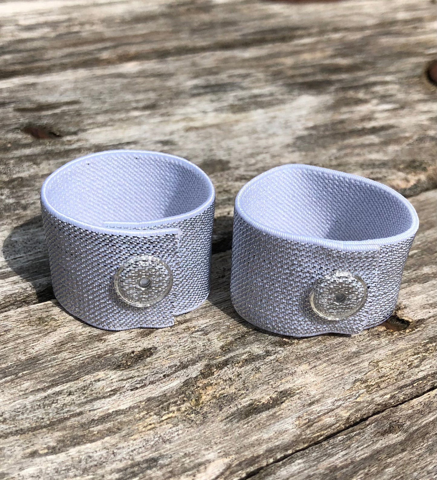 pair of white and silver sleeve clips with snaps