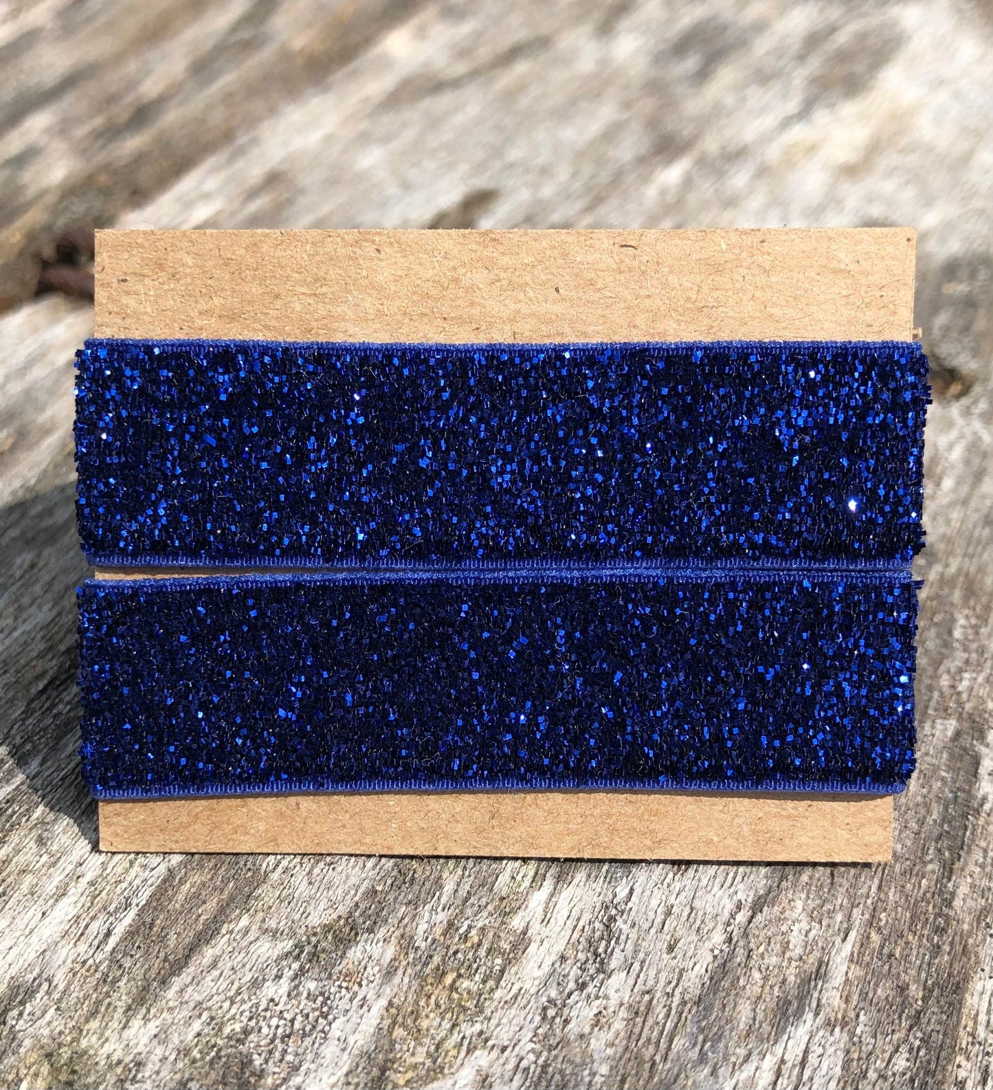 glittery navy blue sleeve clip set on cardboard display