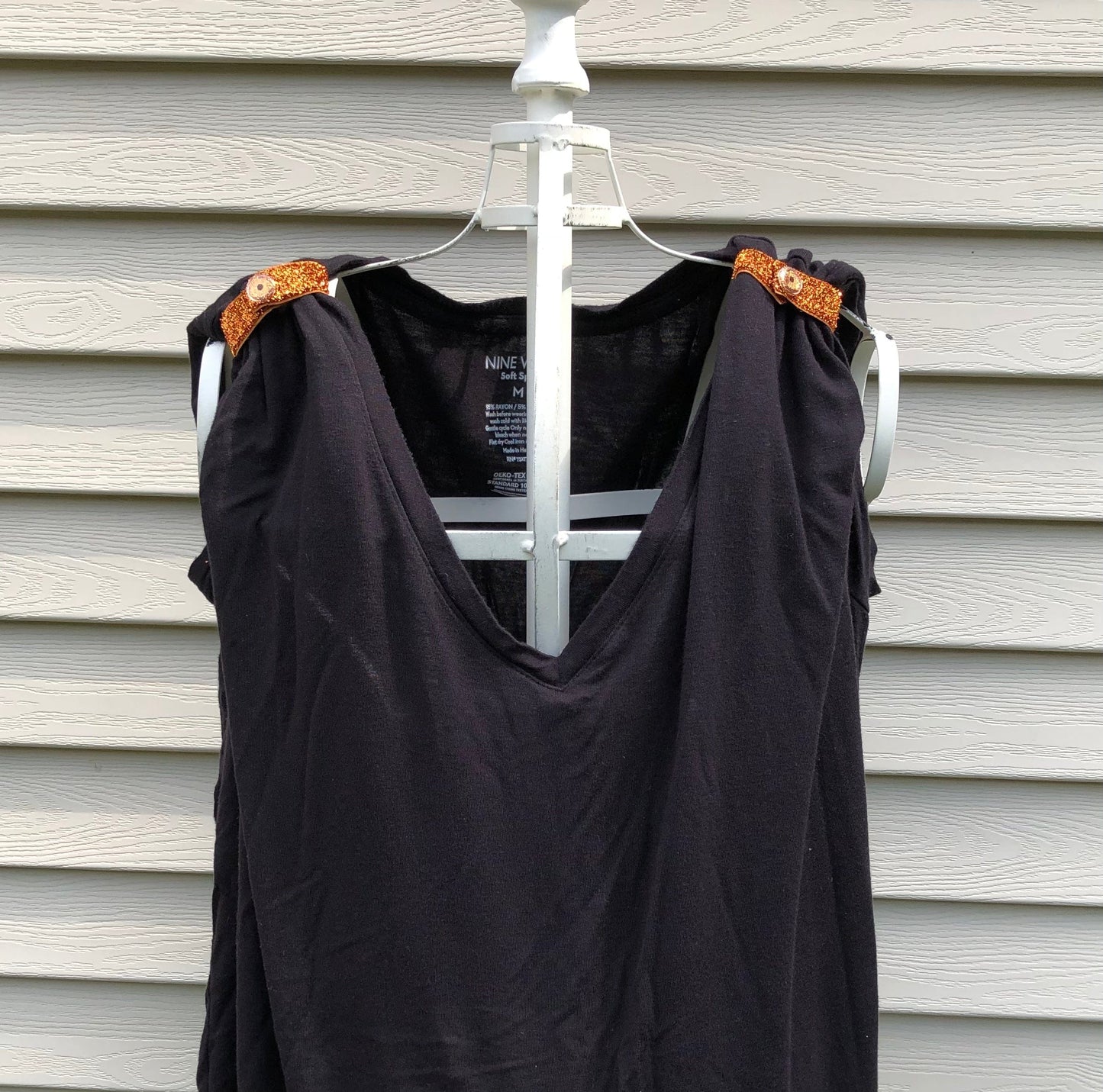 sparkly orange sleeve clips on black tshirt