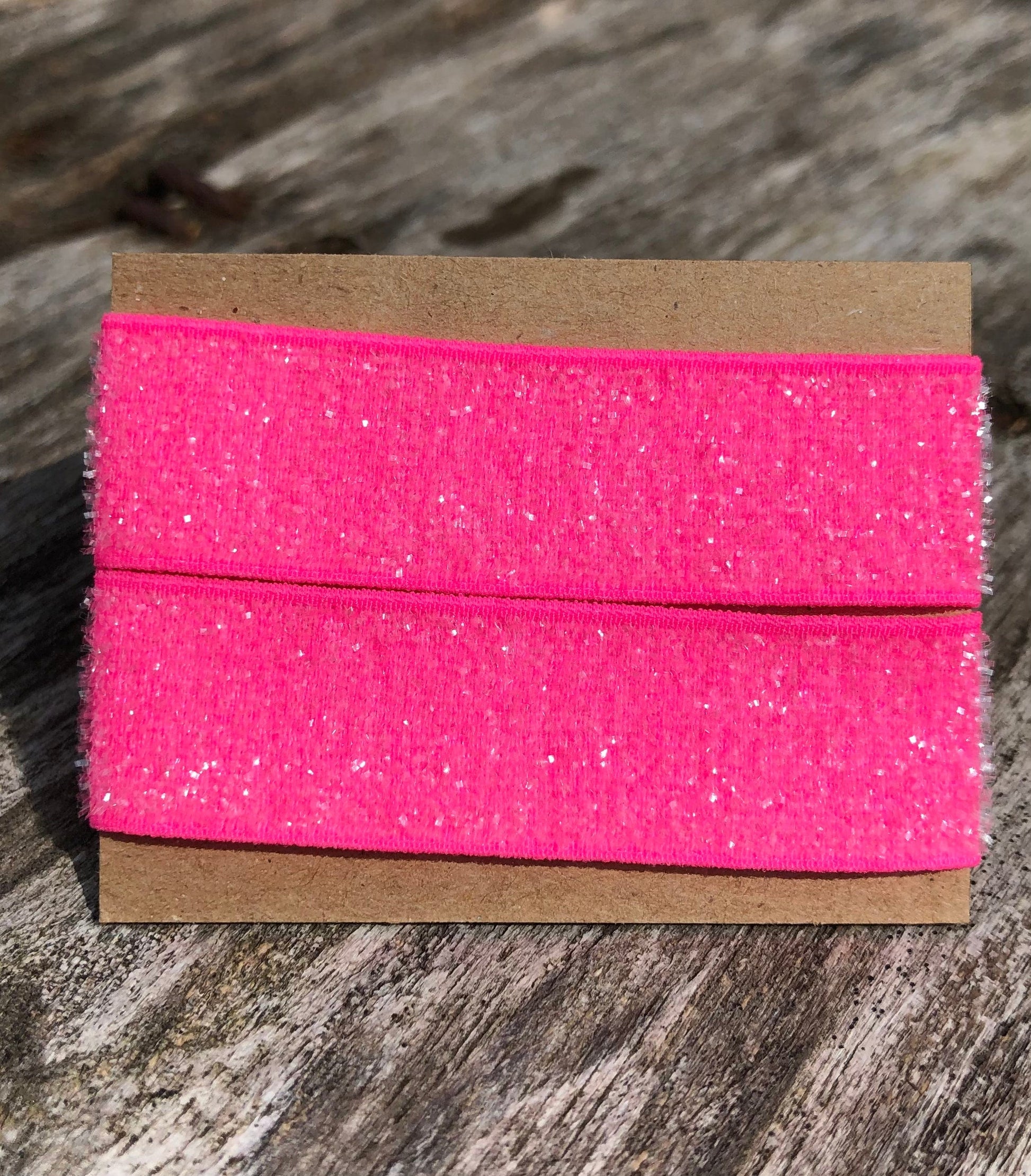 sparkly pink sleeve clip set on cardboard display