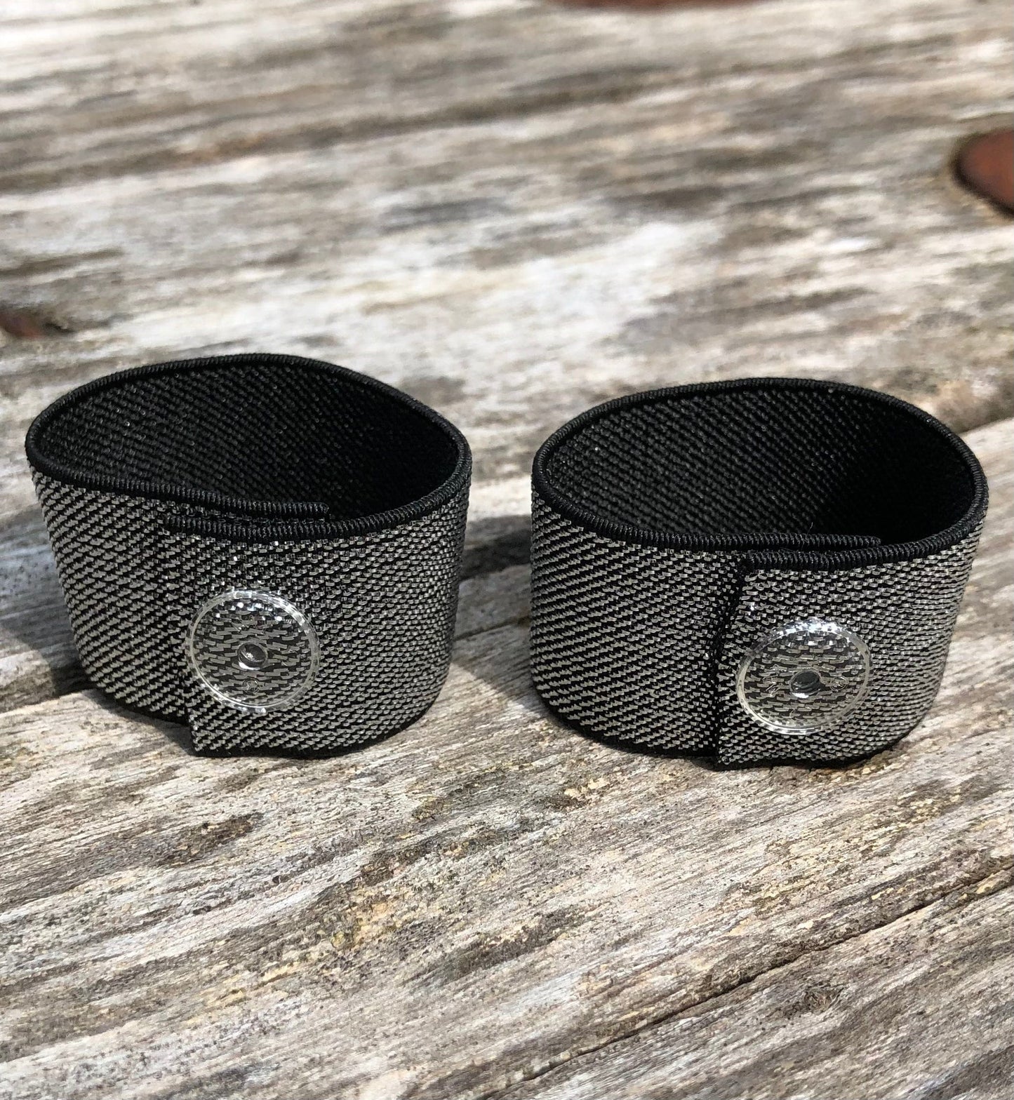 pair of black and silver sleeve clips with clear snaps