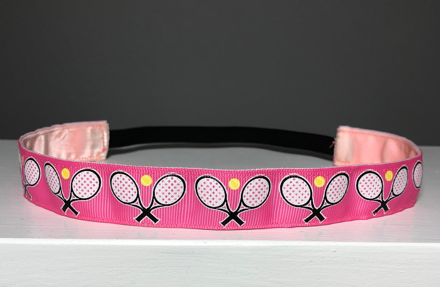 pink tennis headband on tabletop