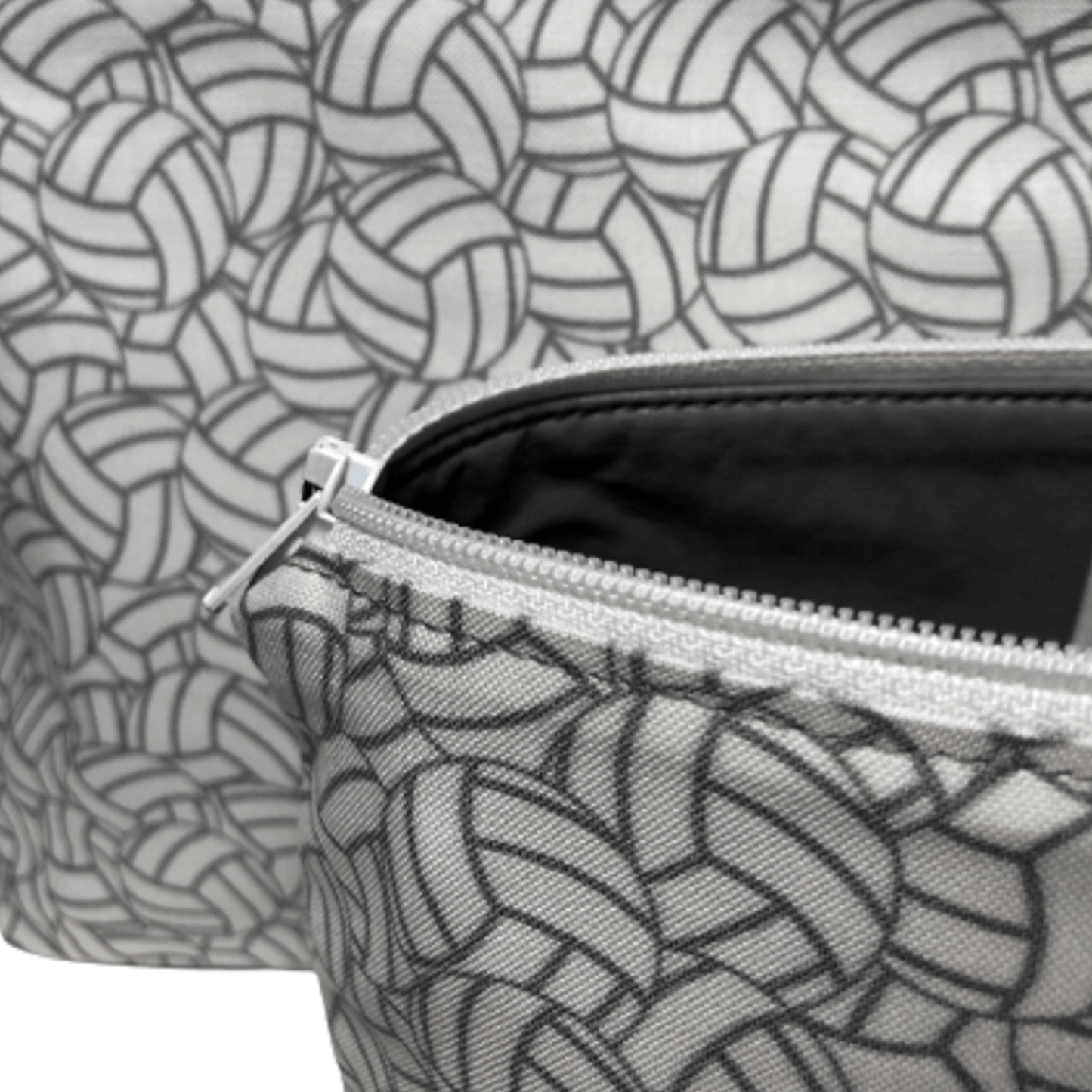 close view of inside gray fabric of white and gray volleyball bag with white zipper