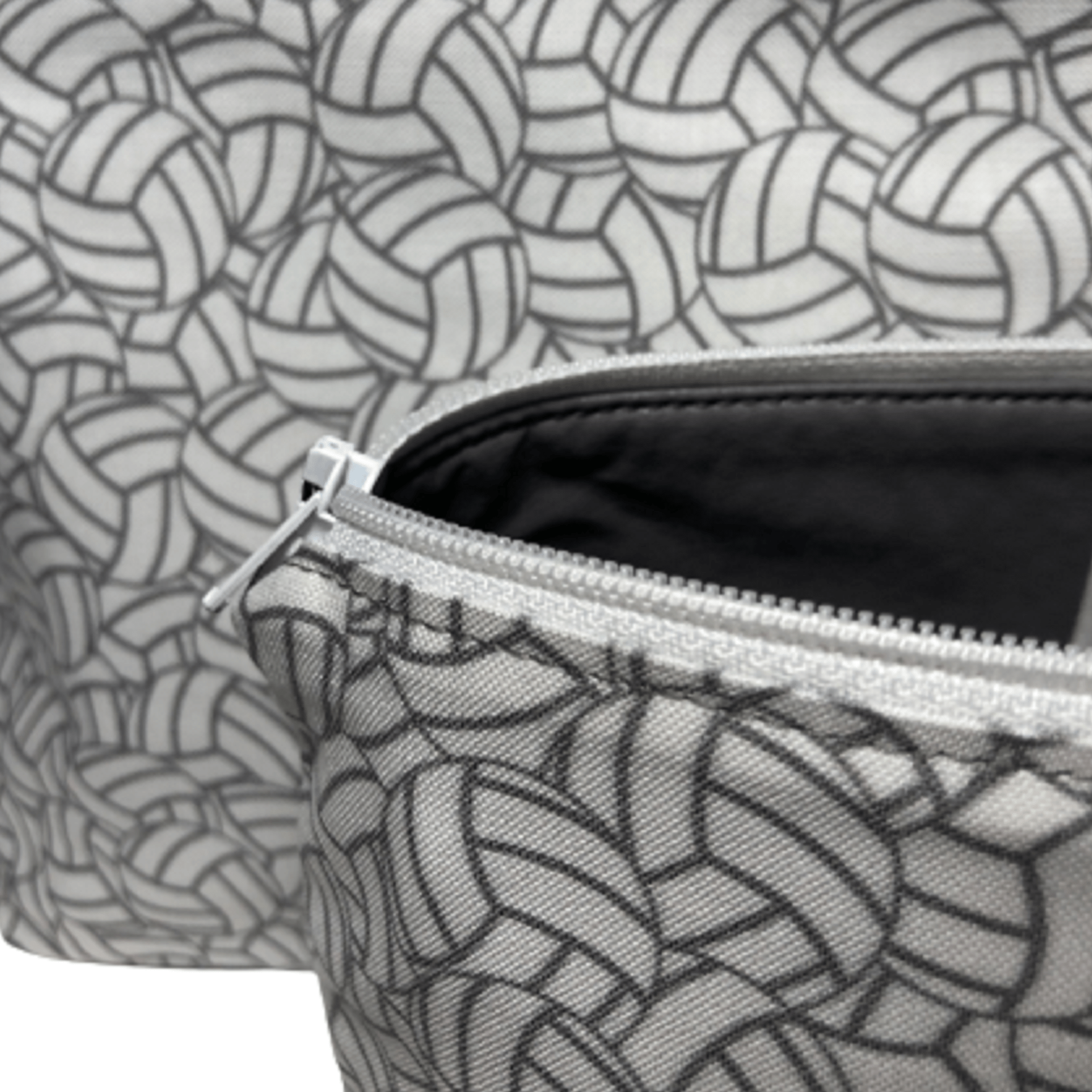 close view of inside gray fabric of white and gray volleyball bag with white zipper