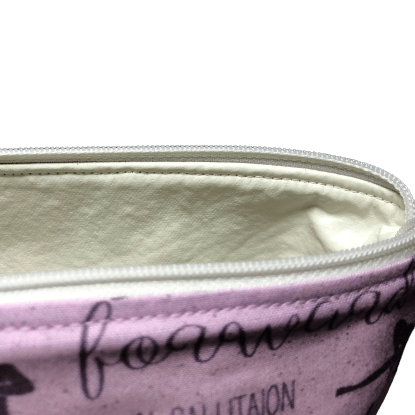 close inside view of zippered bag with off-white vinyl lining and white zipper of light purple bag