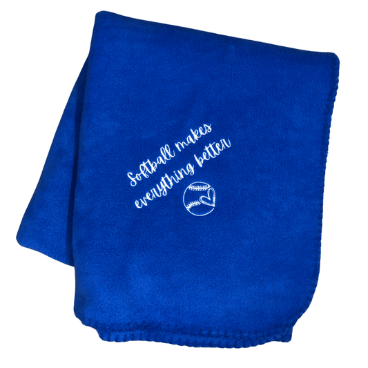 royal blue softball blanket that says softball makes everything bettter with a heart in a softball