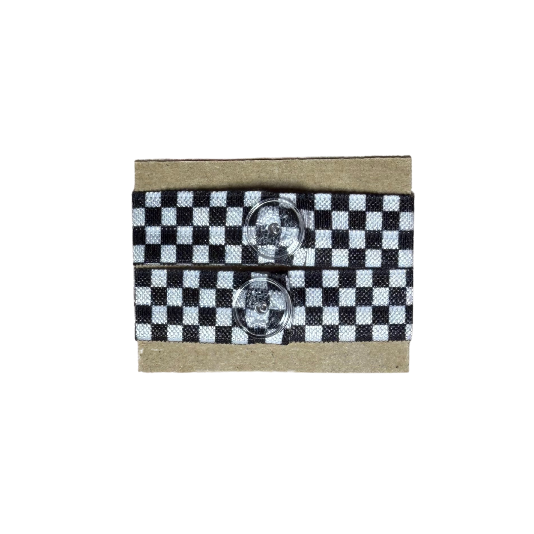 Checkered black and white ribbon sleeve clips with two clear buttons