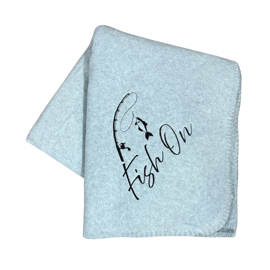 light gray fleece blanket with fish on design embroidered in black thread