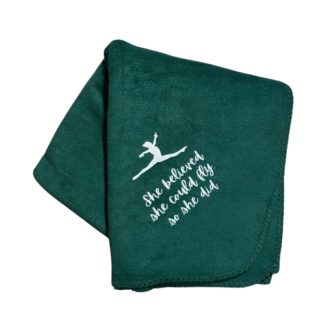 Green gymnastics blanket with white text and graphic