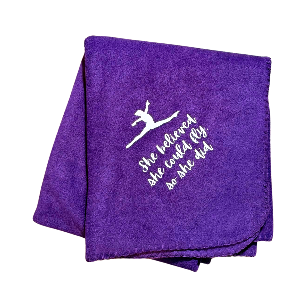 Purple gymnast blanket with white text and dancer illustration