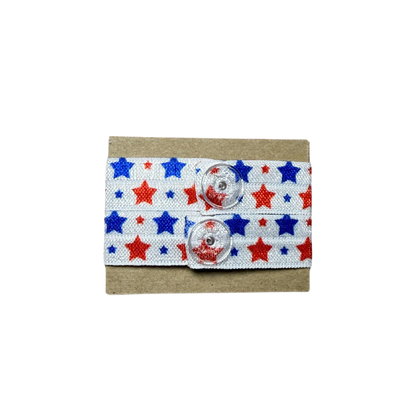 Set of red, blue, and white star-patterned sleeve clips with clear plastic snaps