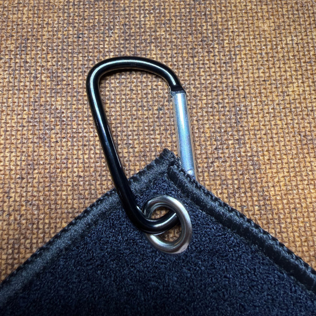 Black carabiner attached to a black microfiber towel