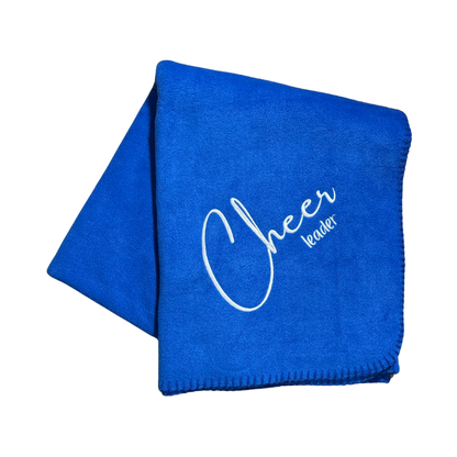 Blue blanket with 'Cheer Leader' text in white stitched embroidery