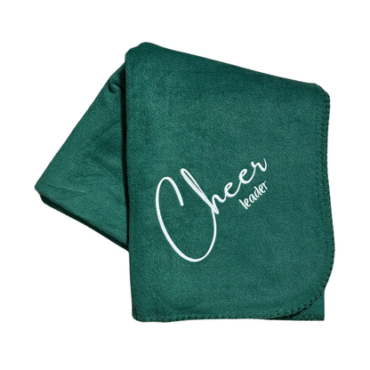 green blanket with cheerleader text embroidered in white thread