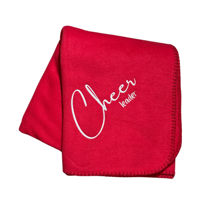 red fleece blanket with "cheerleader" embroidered in white