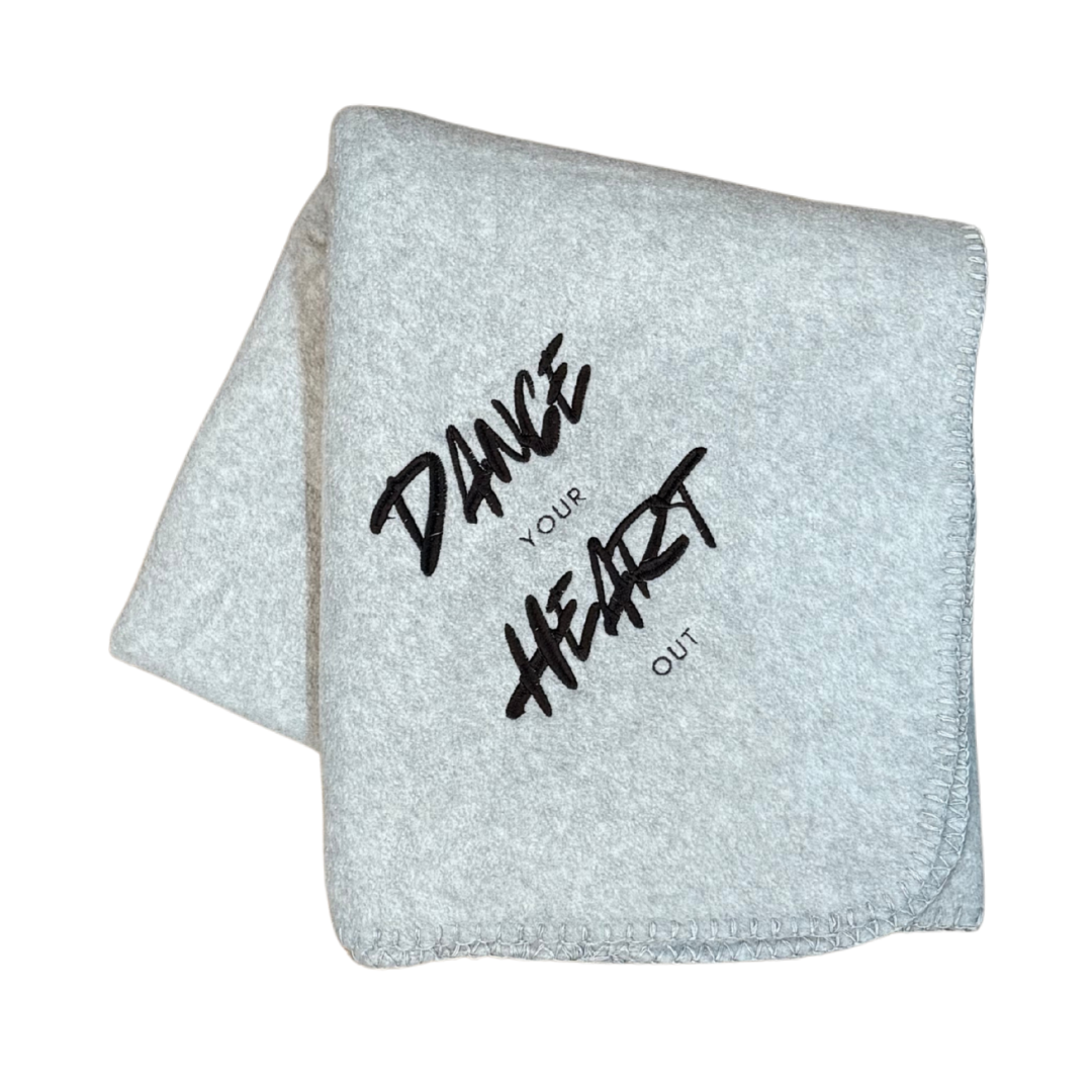 gray dance blanket embroidered with Dance your heart out in black thread