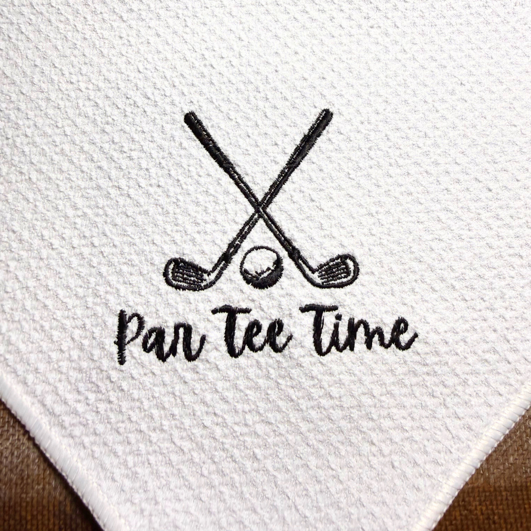 Embroidered design of crossed golf clubs with a golf ball and 'Pan Tee Time' text on white microfiber towel