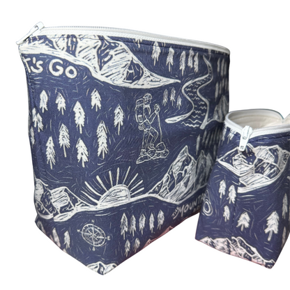 Two blue pouches with white nature-themed designs on a navy blue background