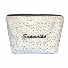 Load image into Gallery viewer, personalized hockey makeup bag with sticks and pucks and name samantha embroidered in black script
