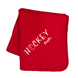 red hockey mom blanket with a hockey puck as the O in hockey