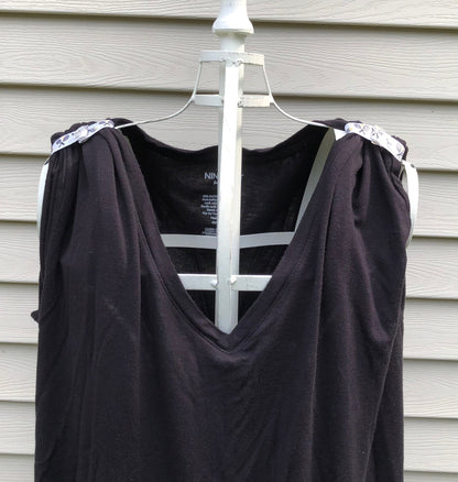 black tshirt on mannaquin with sleeves rolled up and held in place with sleeve clips