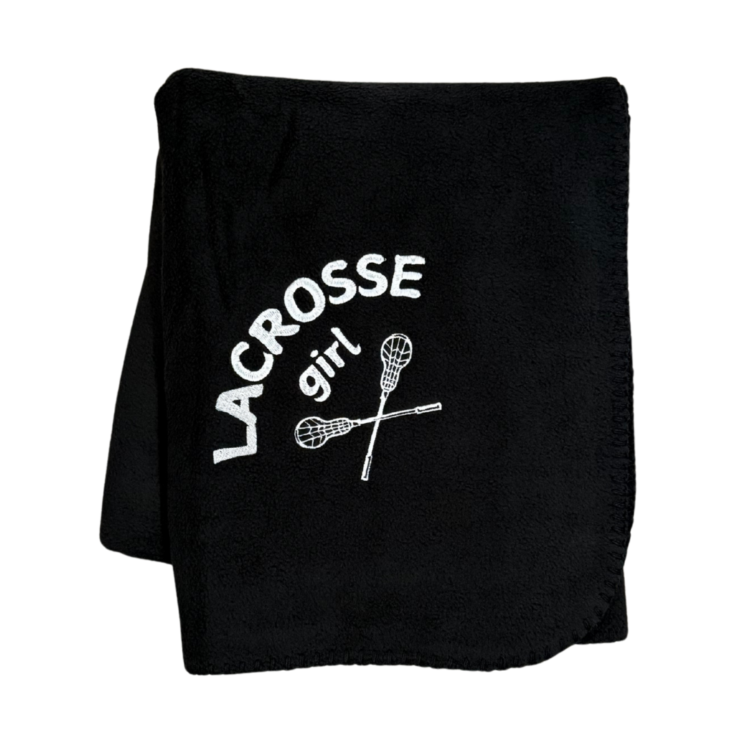 black lacrosse blanket with lacrosse girl and sticks embroidered in white