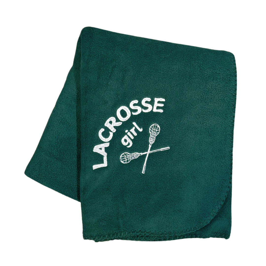 green lacrosse blanket with lacrosse girl and sticks embroidered in white