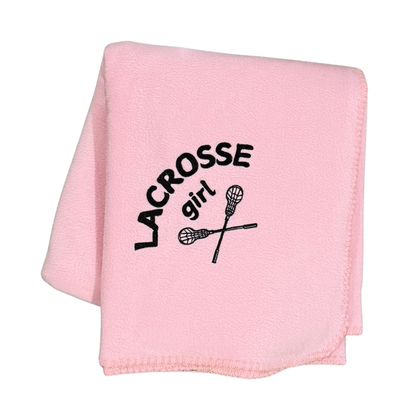 Pink blanket with 'Lacrosse girl' text and lacrosse stick graphics in white stitching