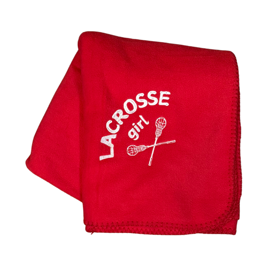 red lacrosse blanket with lacrosse girl and sticks embroidered in white