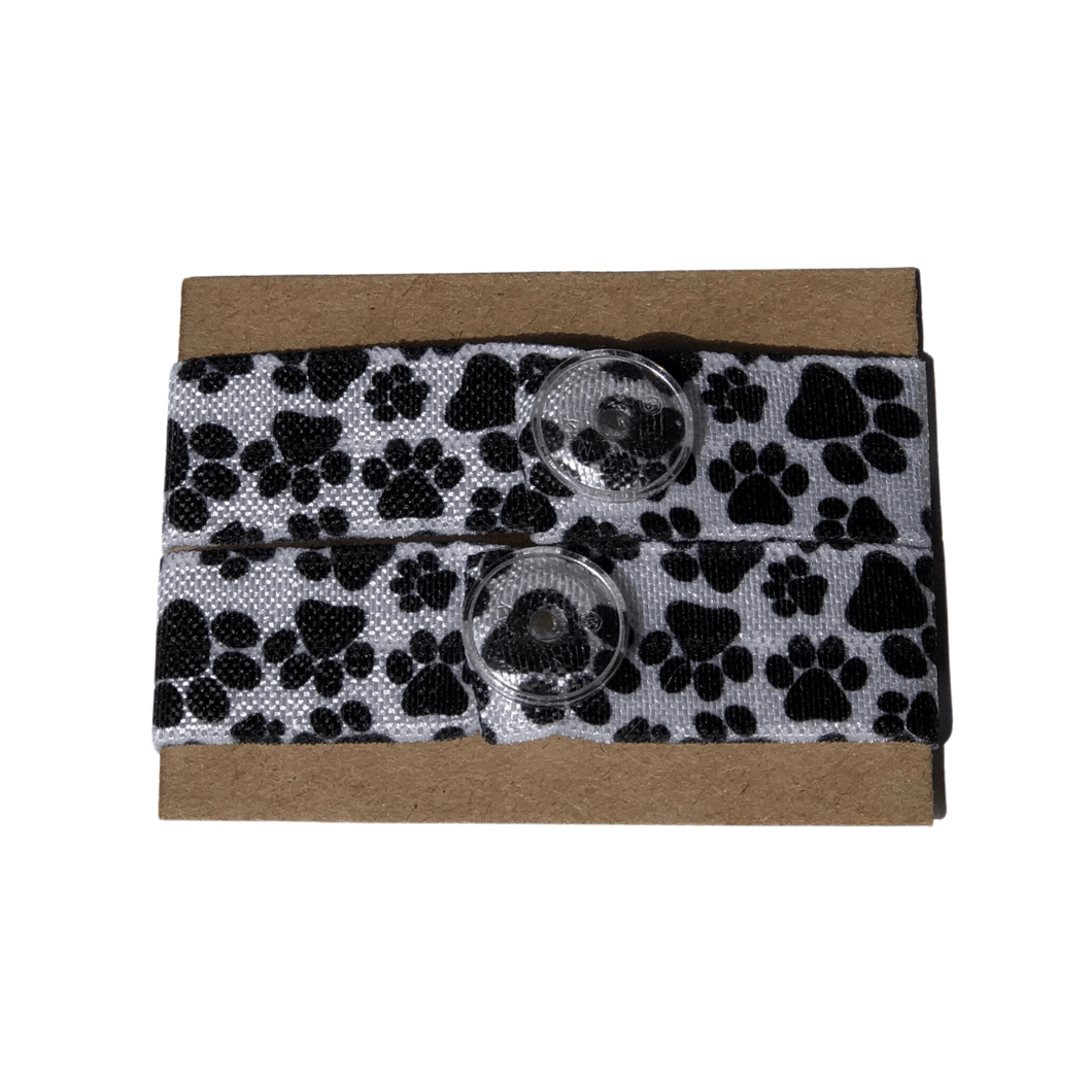 set of white sleeve clips with black paw prints