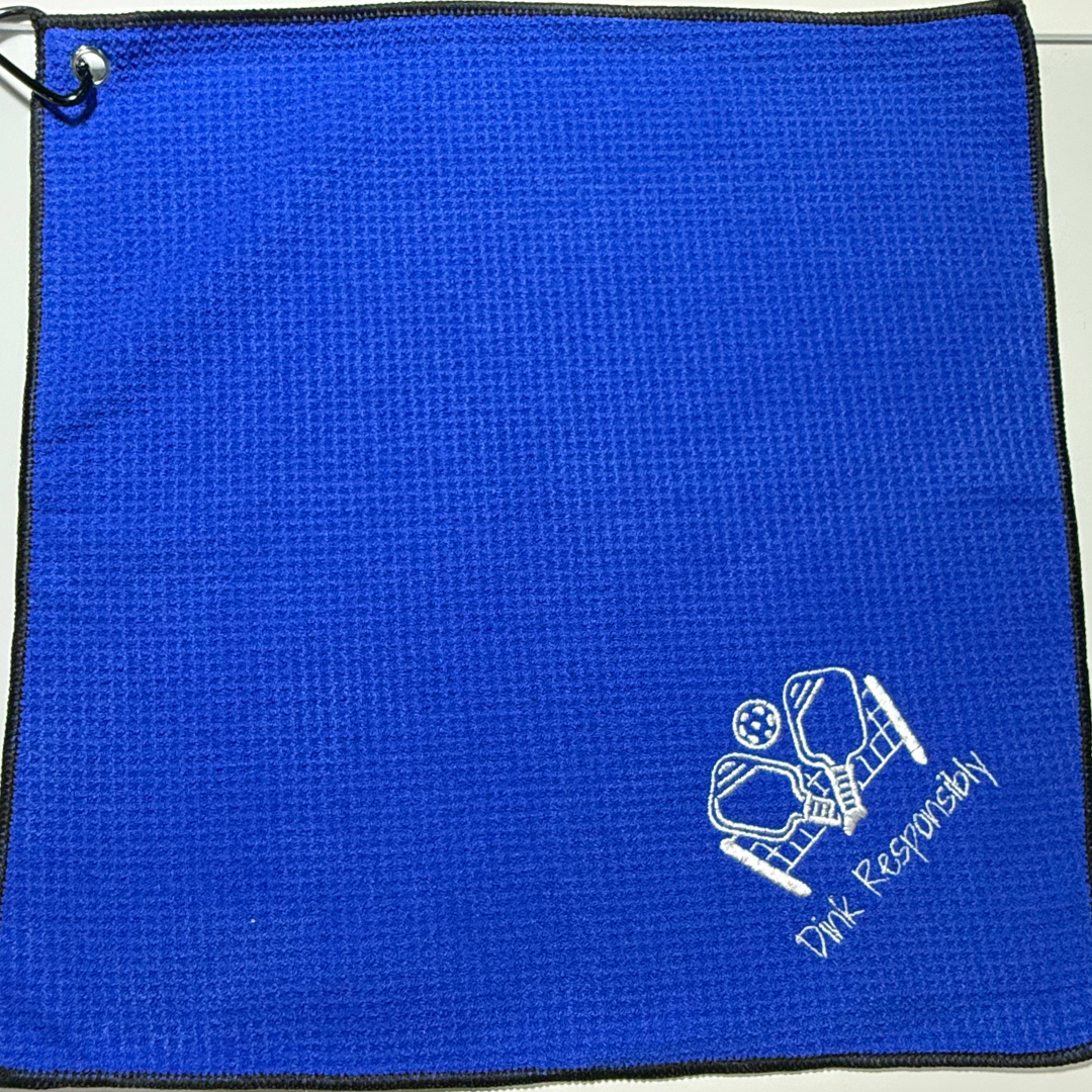 Blue towel with white pickleball text and design on a white background
